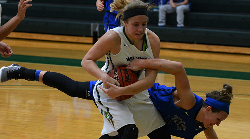 Sophomore Mackenzie Campbell battles a Thomas More player for a rebounds Wednesday. (Wilmington photo/Randy Sarvis)