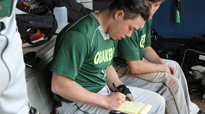 After every at-bat Joshua Chua records relevant data in his notebook. Chua, a transfer, is a vital member on and off the field. (Wilmington Athletic Communications photo)