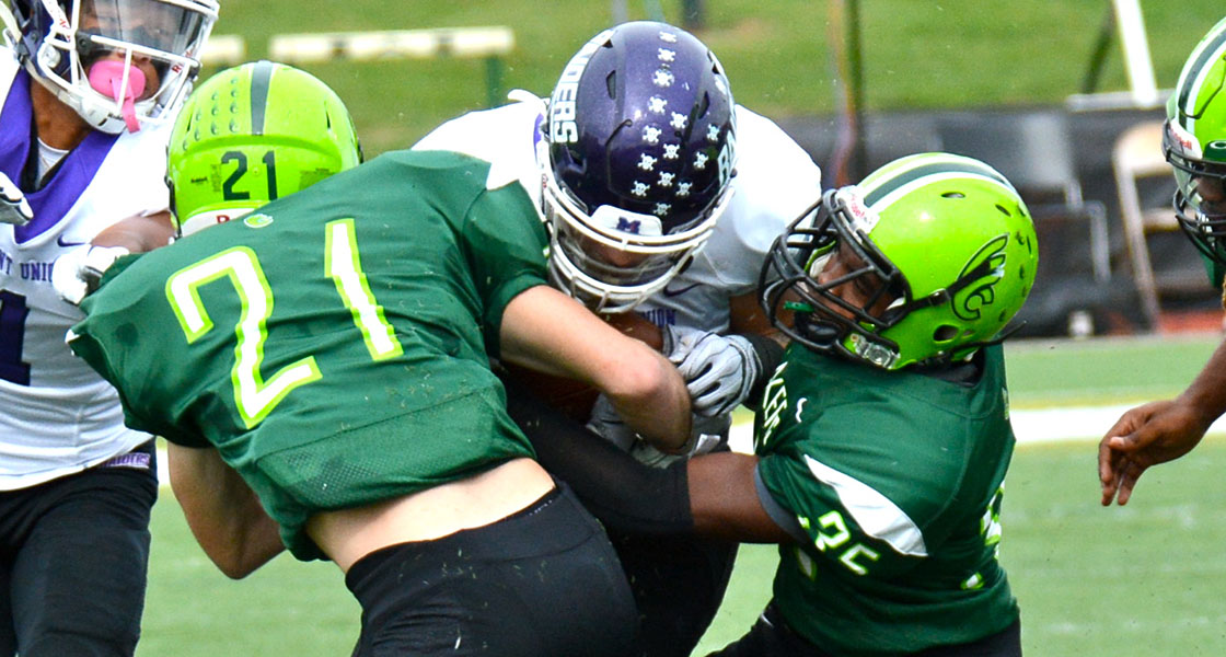 Freshmen Olen Kiel (21) and Leroy Wilson combine for a tackle in Saturday's loss to Mount Union. (Wilmington photo/Randy Sarvis)